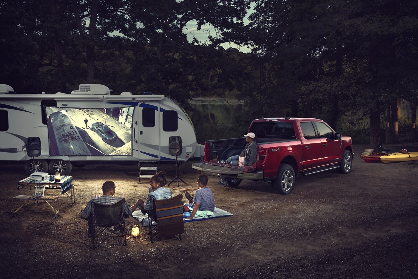 2023 Ford F-150 parked at a campsite with a family attached to an RV
